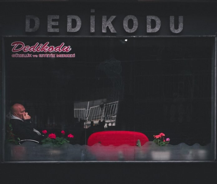 a man sitting in a chair in front of a window