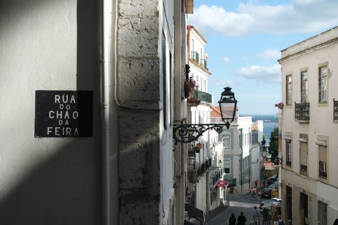 image_1785578438903 a narrow street with a sign on the side of it
