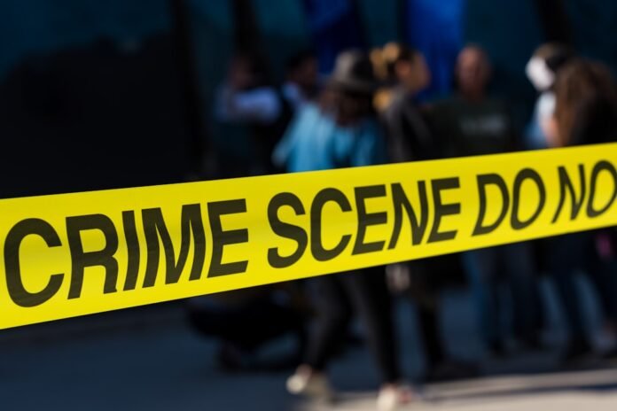 image_1785643235586 a group of people standing next to a yellow police line