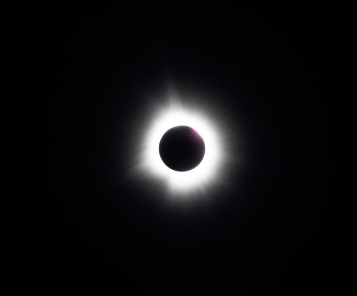 a solar eclipse is seen in the dark sky