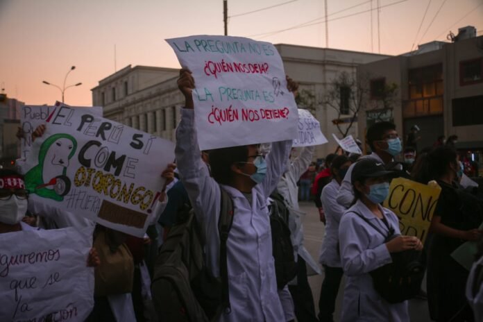 people holding white and blue banner