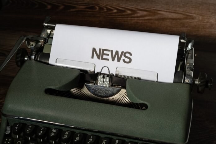 image_1786431634141 a close up of a typewriter with news paper on it