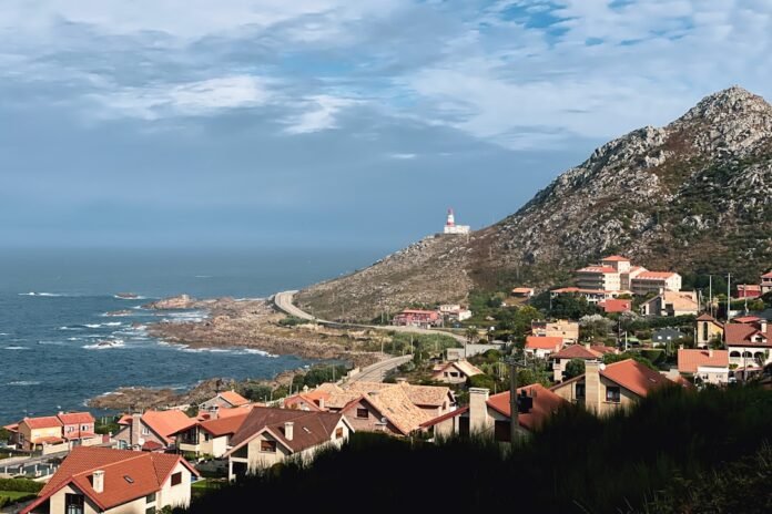a scenic view of a town by the ocean