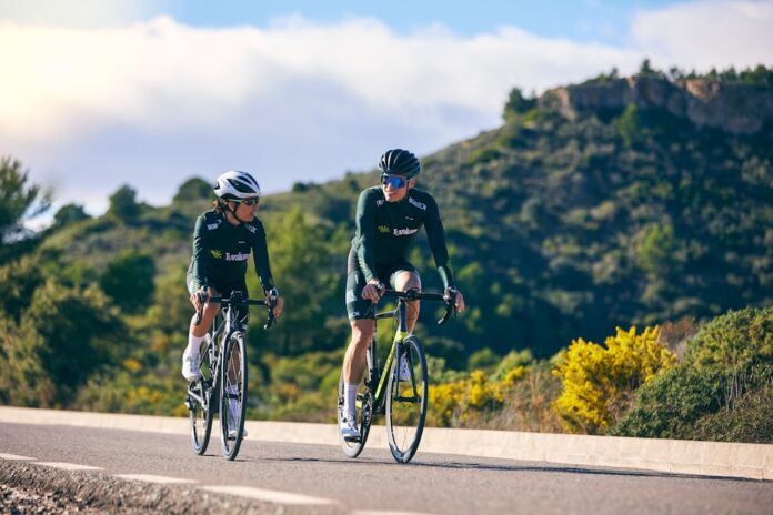 image_1786885233254 a couple of people riding bikes down a road
