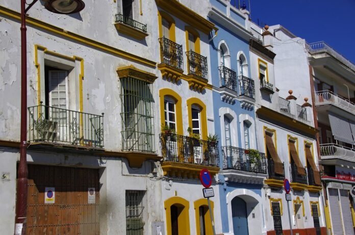 a row of multicolored buildings with balconies