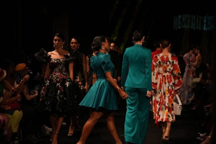 Models walk the runway in diverse fashion show outfits