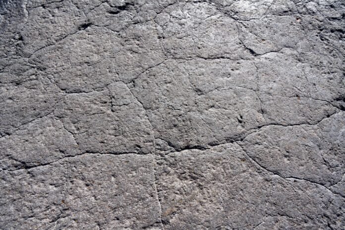 a close up of a rock surface with small cracks