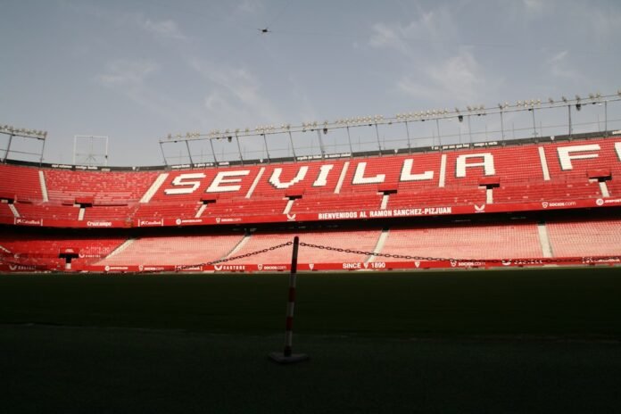 A large stadium with red seats and
