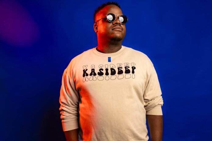 Man in sunglasses and sweatshirt on blue background