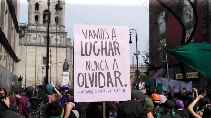 image_1787630430920 Protest sign reads: "we will fight, never forget."