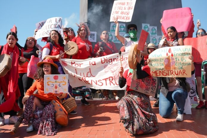 a group of people holding signs and banners