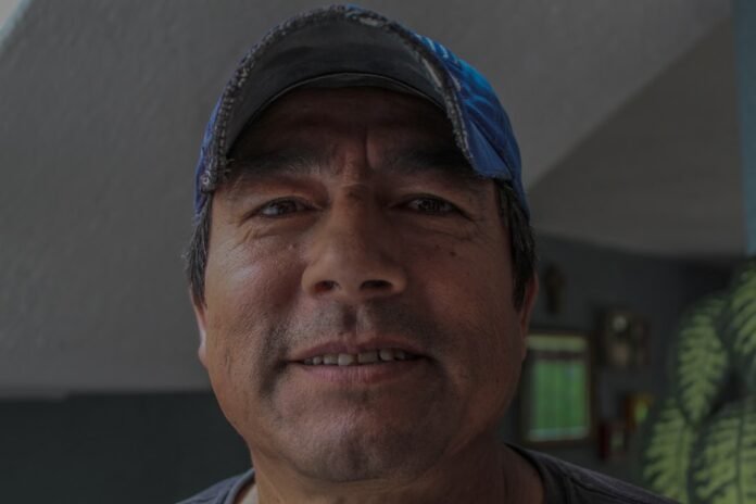 man wearing blue curve-brim cap