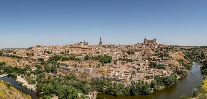 Historic city panorama with river under clear blue sky