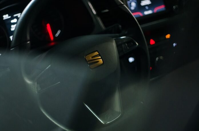 black car steering wheel with yellow light