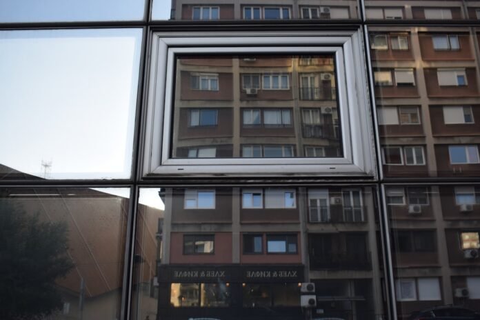 A reflection of a building in a window