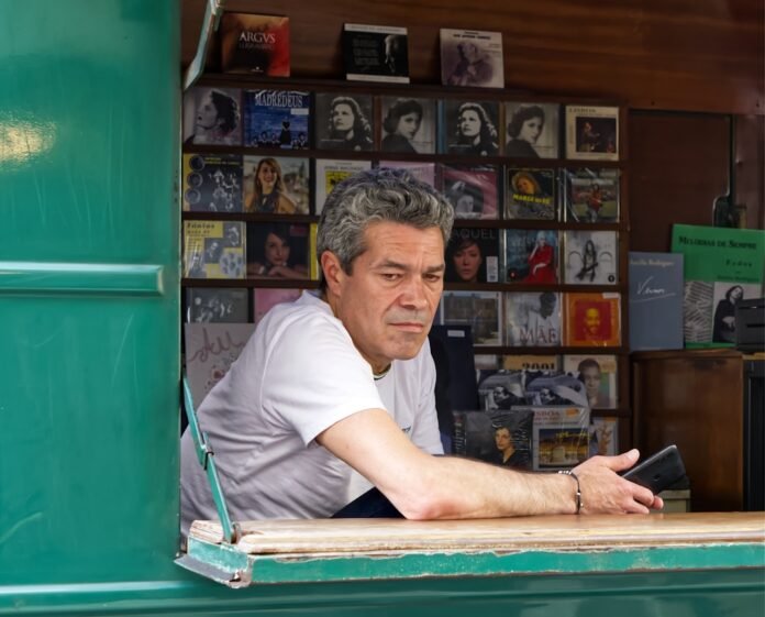 Man at record store looks pensive