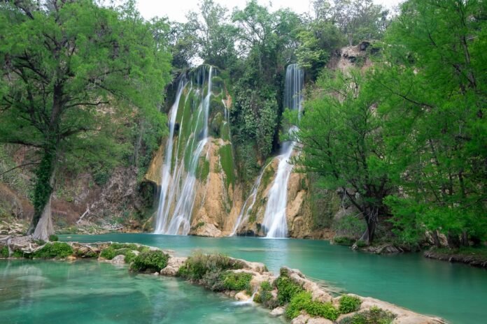 a large waterfall is in the middle of a river