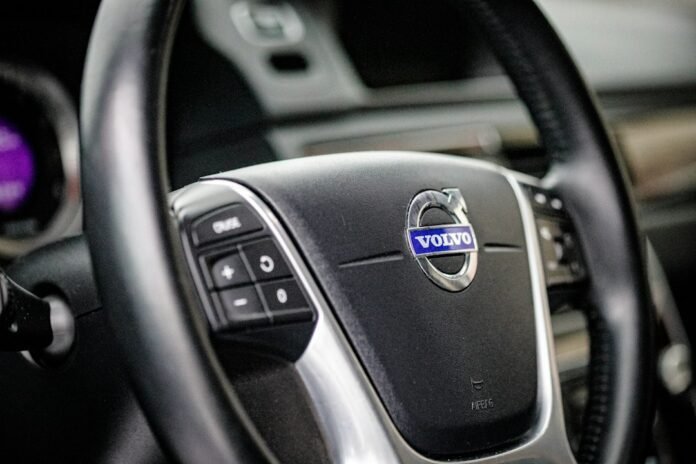 the steering wheel of a car with a volvo sticker on it