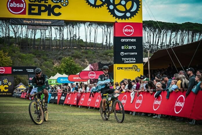 A group of people riding bikes down a race track