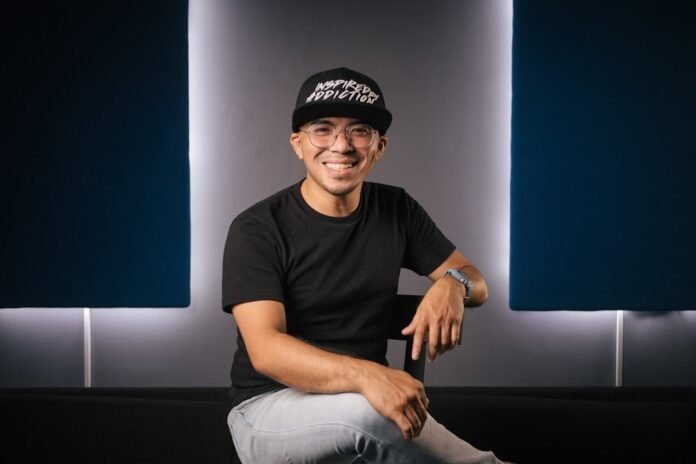 a man sitting on top of a black couch