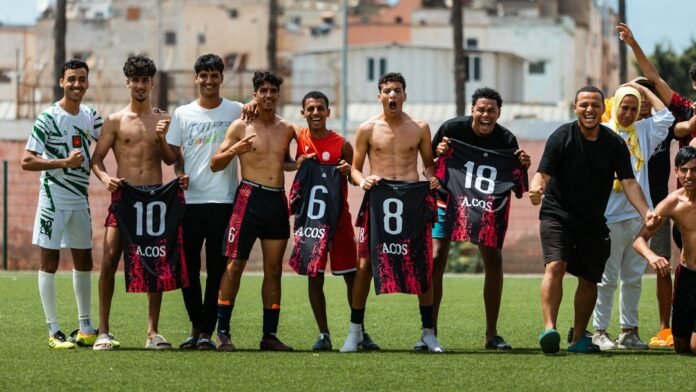Soccer team poses with jersey numbers