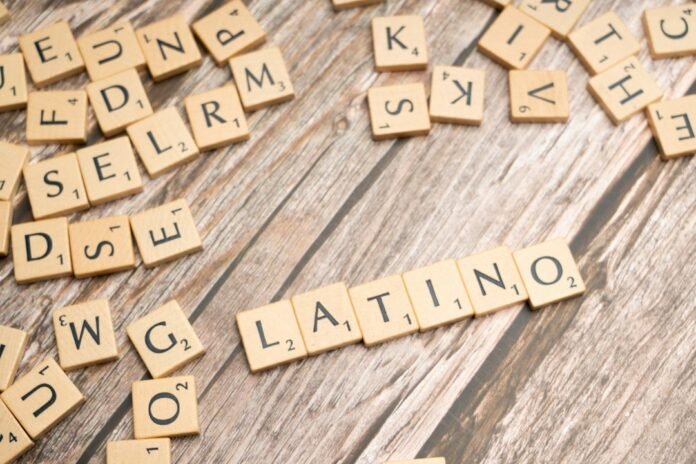scrabble tiles spelling the word latin on a wooden surface