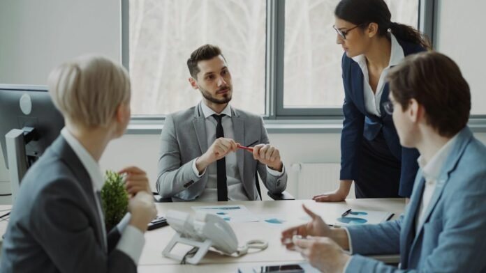 image_1790686836172 Business professionals collaborating around a conference table