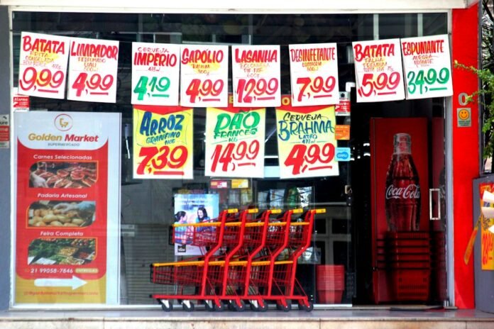 A grocery store window displaying price tags