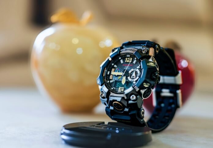 A rugged digital watch displayed on a stand