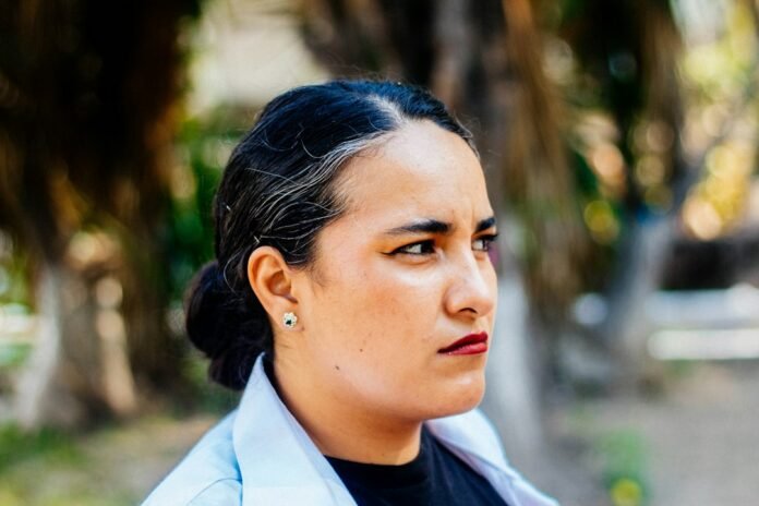 a woman in a black shirt and a white blazer