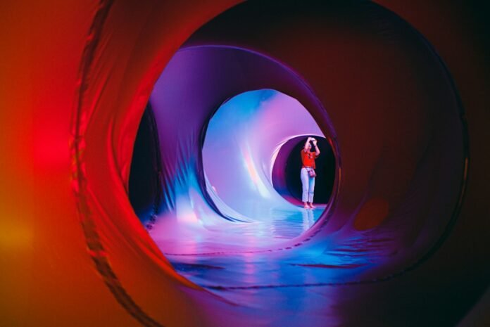 man in blue t-shirt standing in tunnel