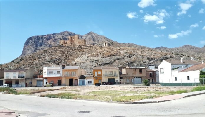 Small town nestled at the base of a large mountain