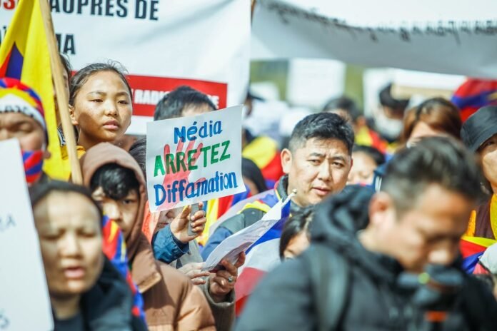 image_1792684837097 a large group of people holding signs and flags